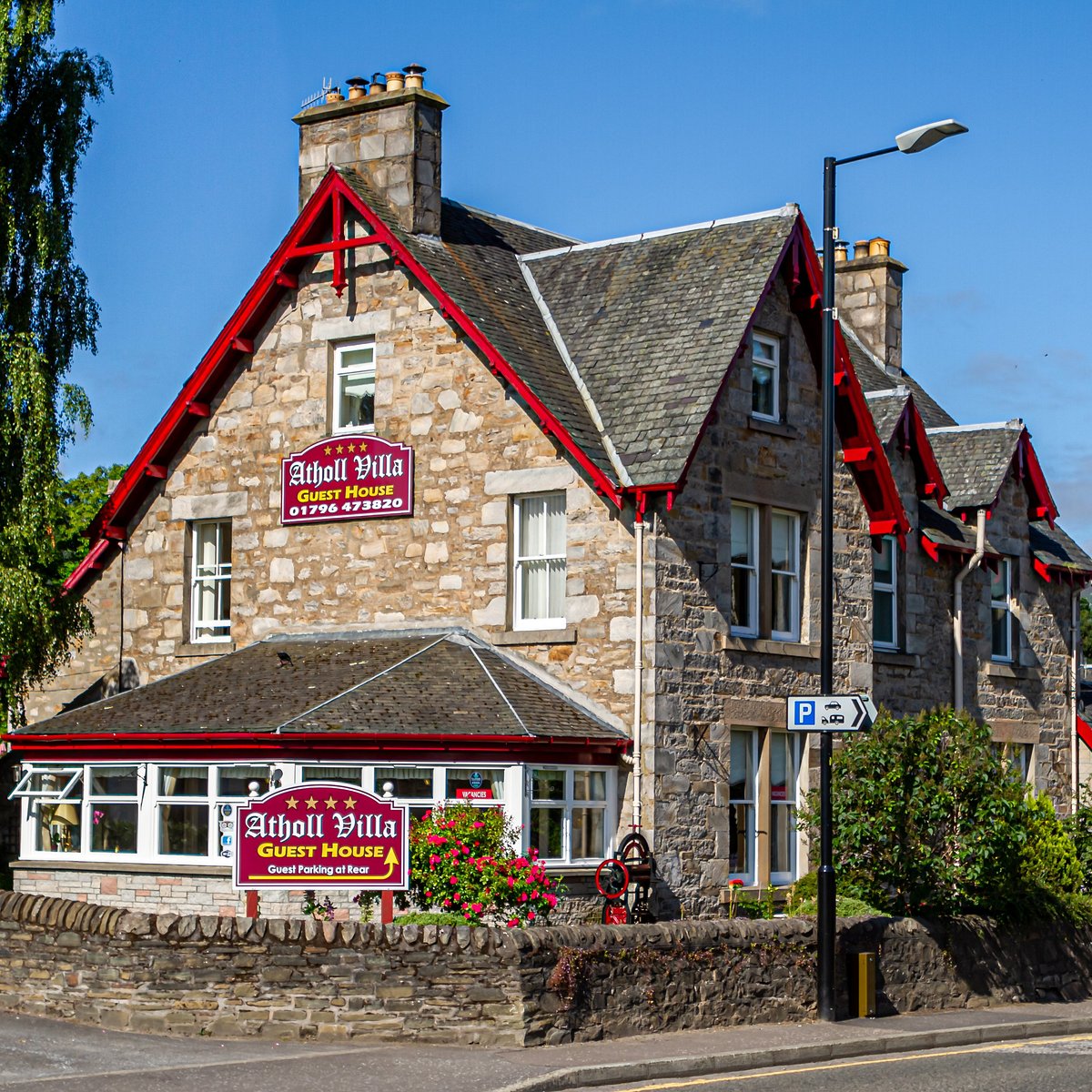 The stone facade and red gables of Atholl Villa Guest House